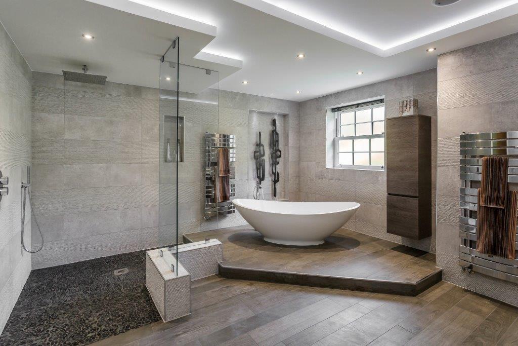 Wood-look tile flooring planks, grey, installed throughout this renovated bathroom