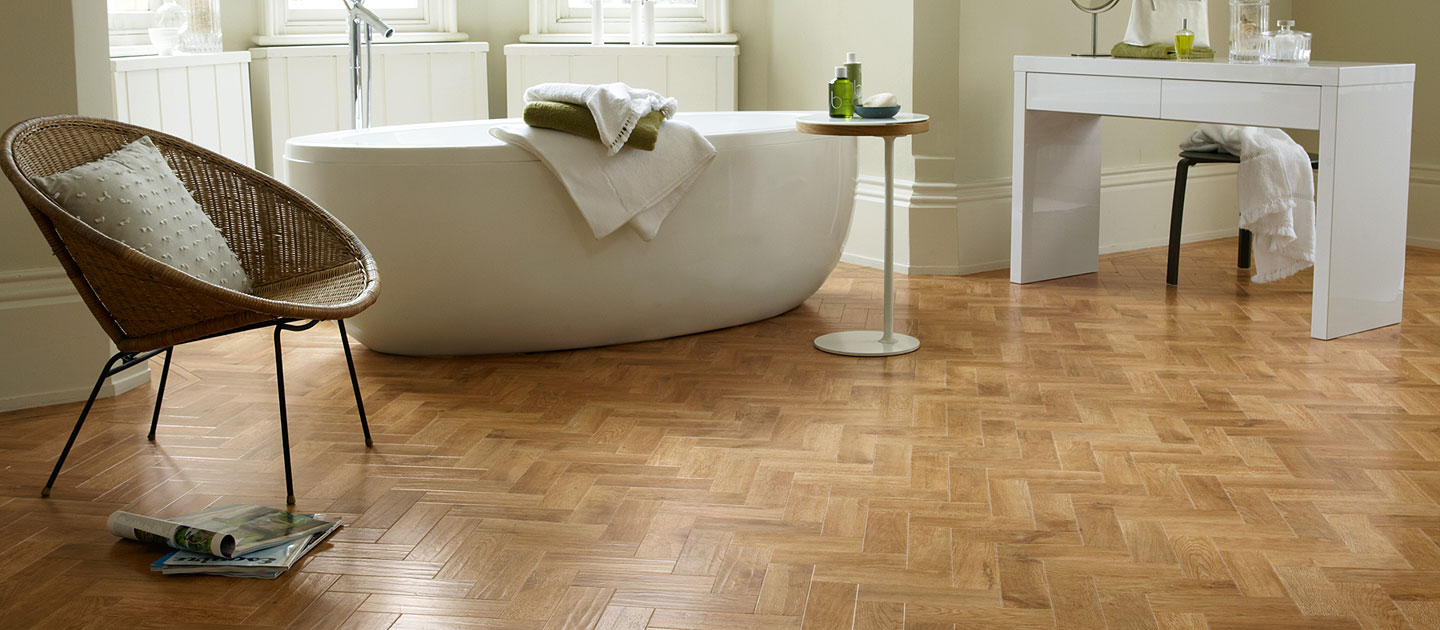 Luxury vinyl in a herringbone pattern installed in a modern open style, luxury bathroom